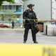 A heavily-armed cop guarding what appears to be the backside of the Tops Friendly Market in Buffalo, New York.